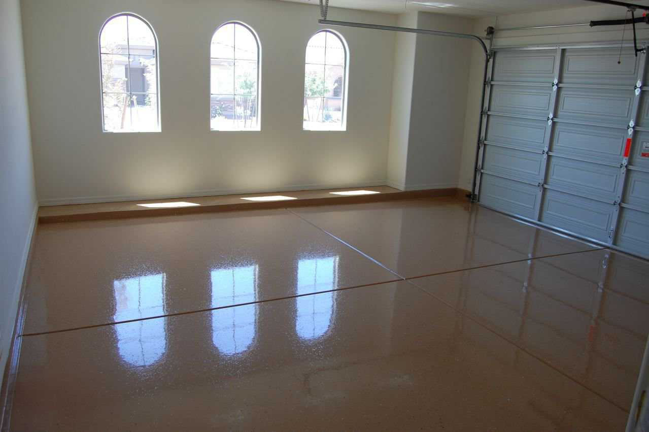 Epoxy-coated garage floor with high-gloss finish reflecting overhead lighting