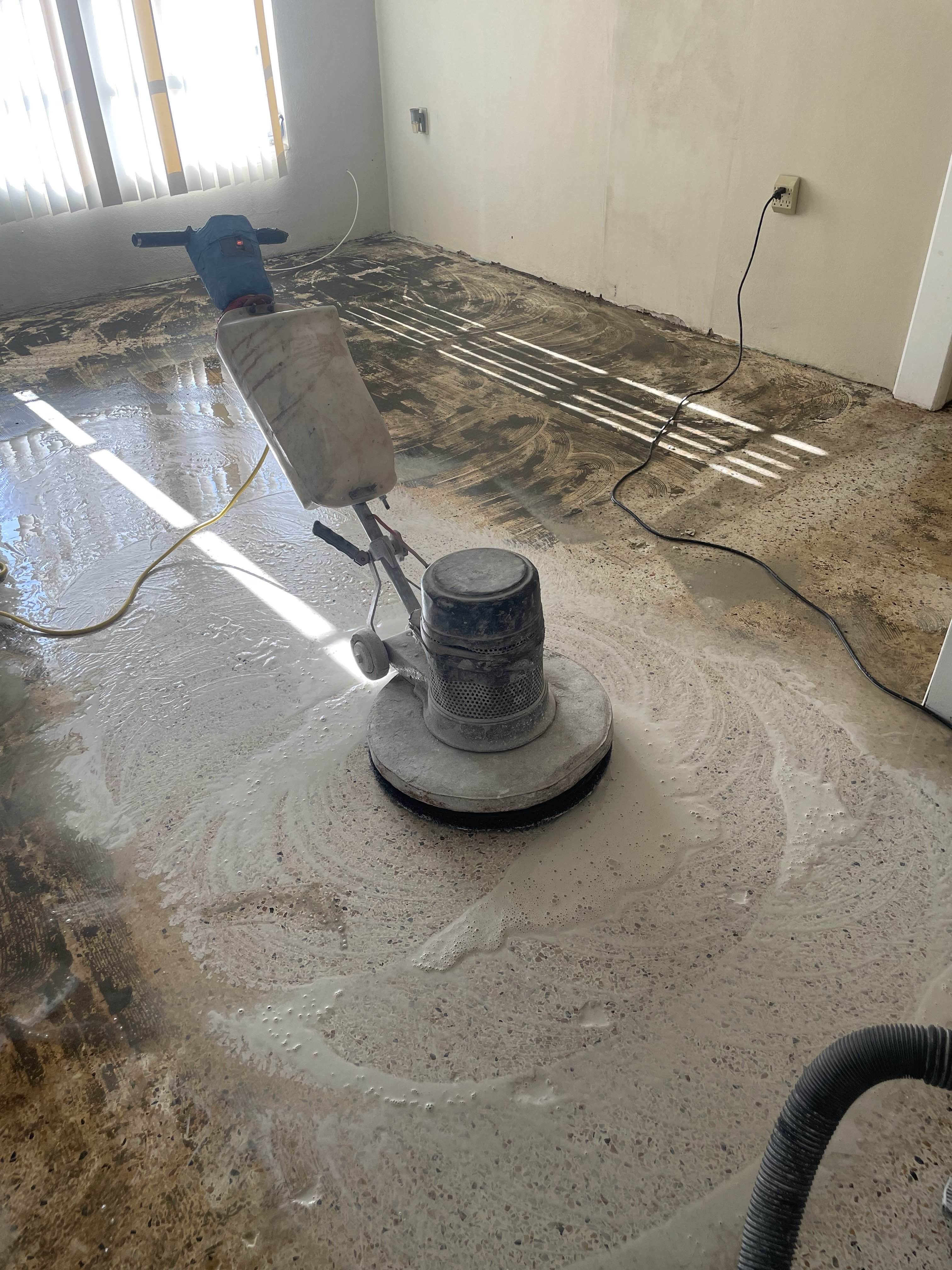 Concrete floor being refinished with polishing equipment in progress